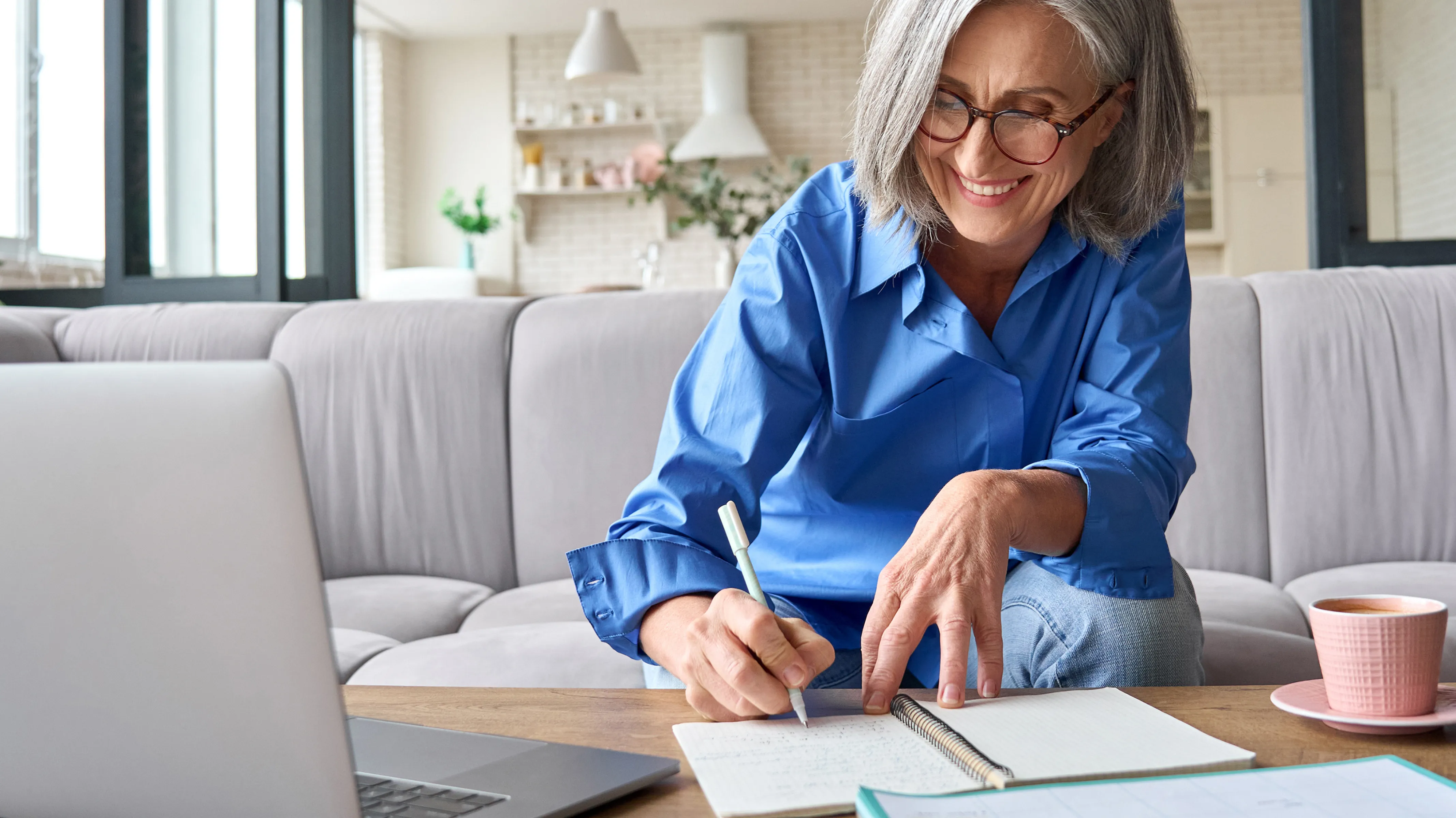 Woman writing in notebook, planning her leadership development