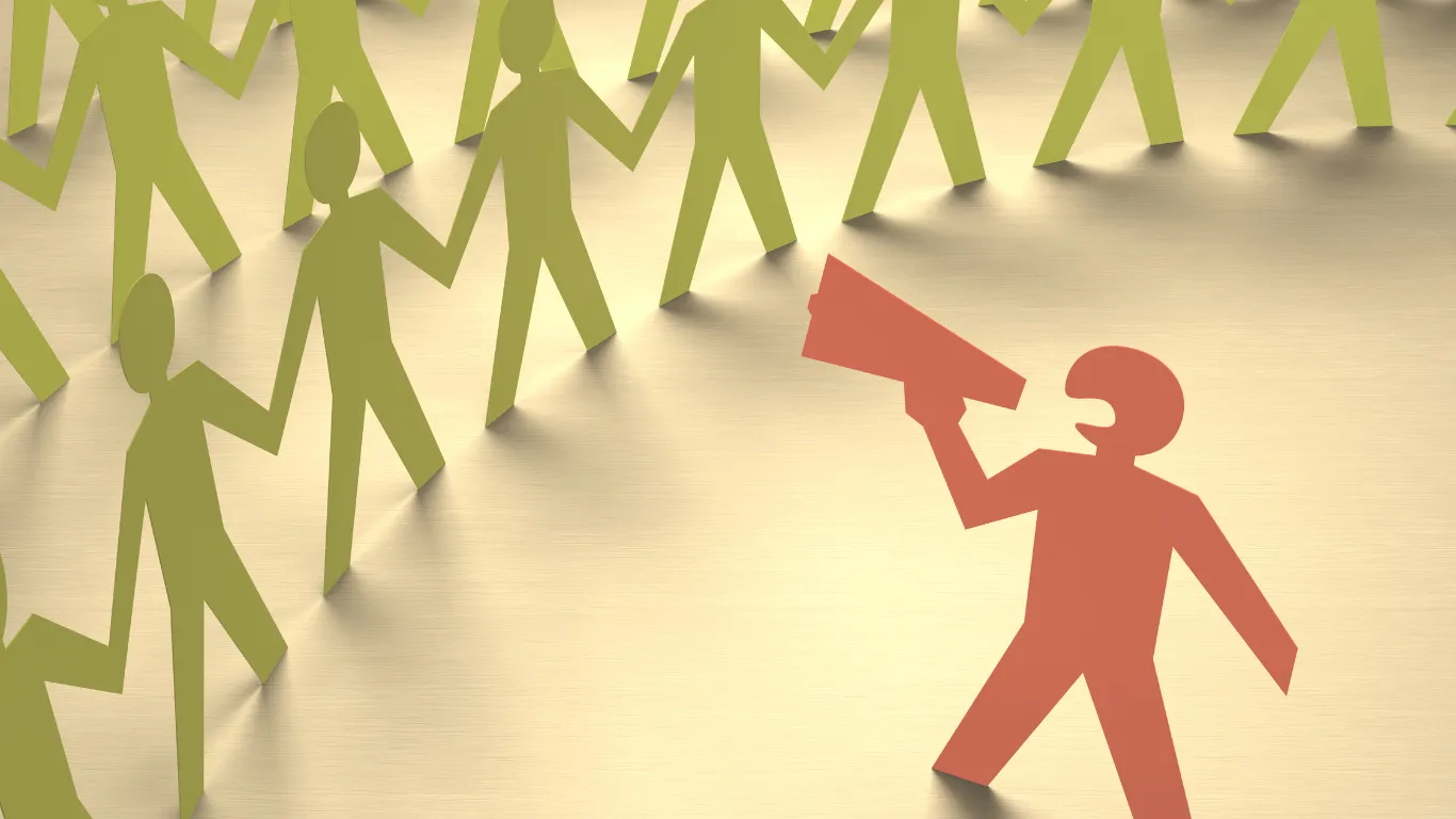 A paper cut-out person using a megaphone to speak to a group of other paper cut-out people